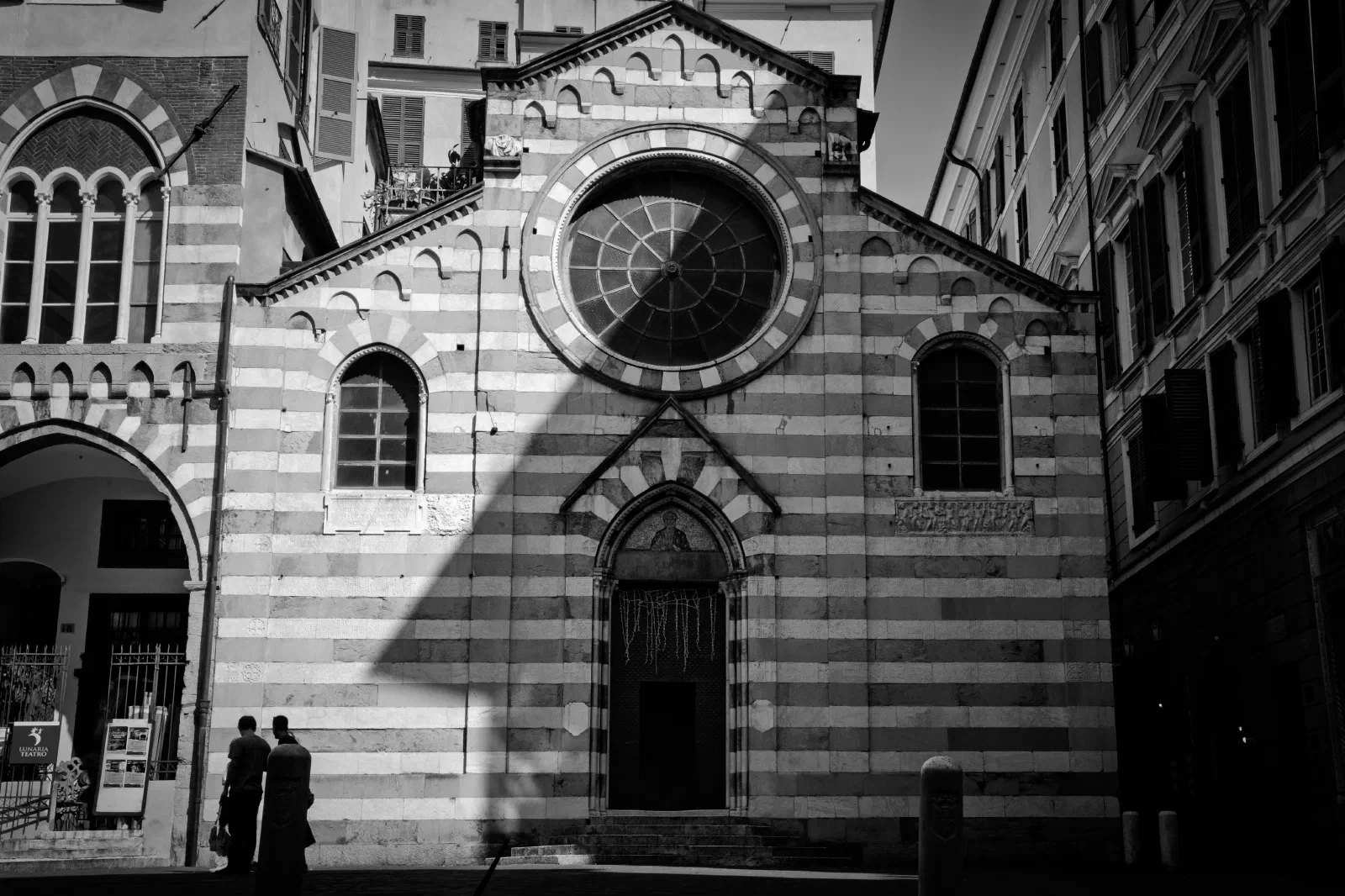 a black and white photo of a church in historic old town of Genoa with black and white marble